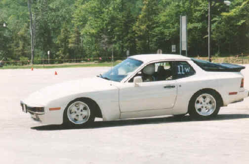 Dolores Fortier
The picture was taken at an autocross. The car is a 1984 944. Just turned over 90000 miles. I bought the car when it had 19000 miles on it back in 1988. Never had anything go wrong with it. Regular maintenance, that's it. Never seen winter. Black leather interior, tan carpeting with black mats. My mechanic thinks under the hood is in excellent shape and very clean. Only 3 speeding tickets but they were whoppers!
